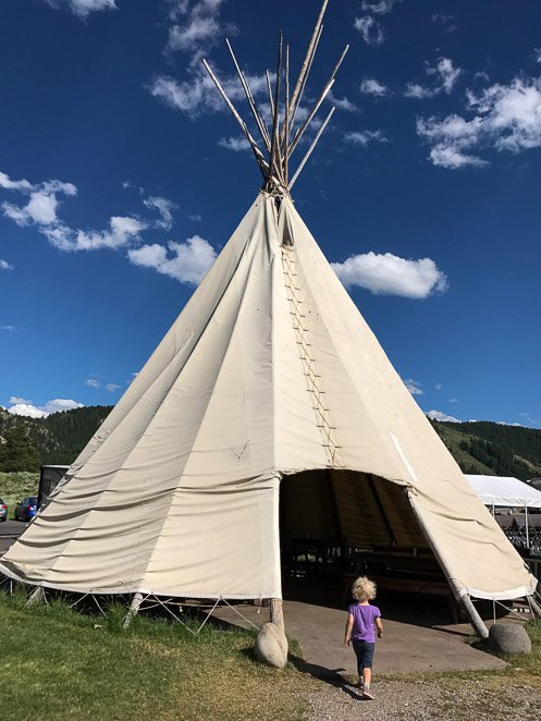 Child walking into Teepee