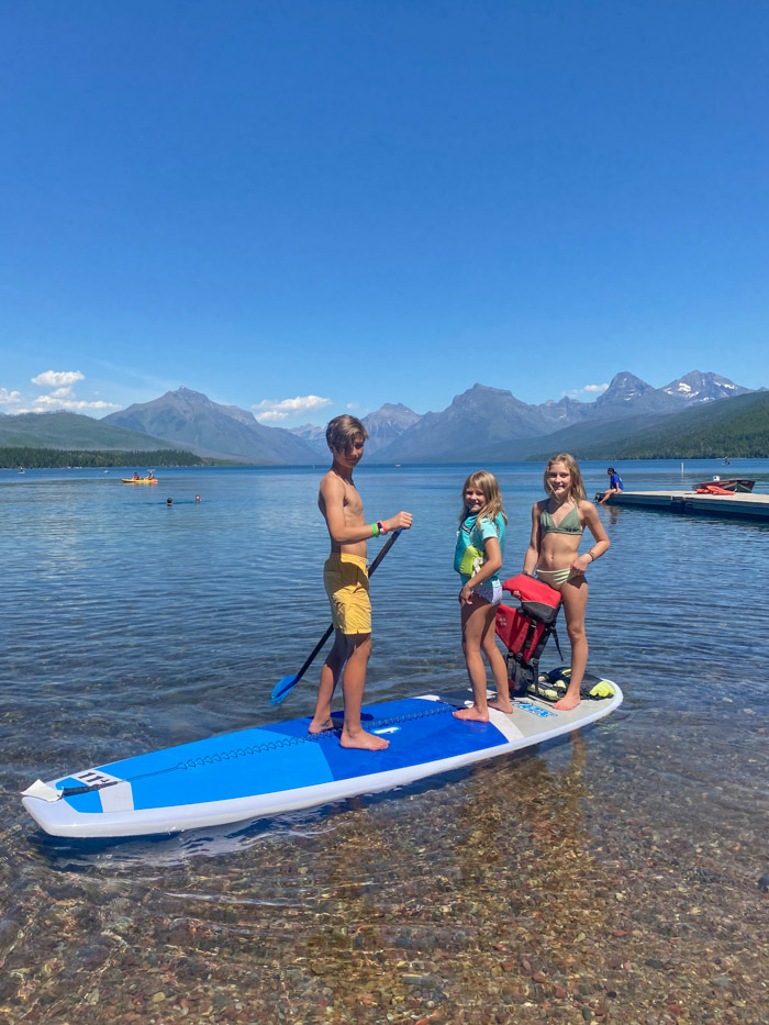 Teens paddleboarding in Glacier NP