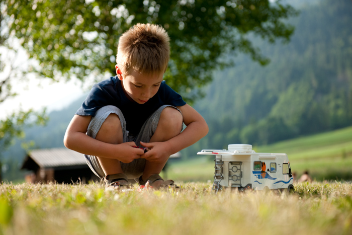 Toy RV Campers boy playing with the camper